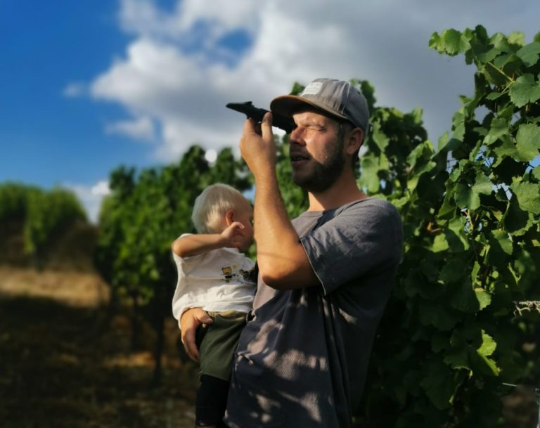 Max in vineyard with child
